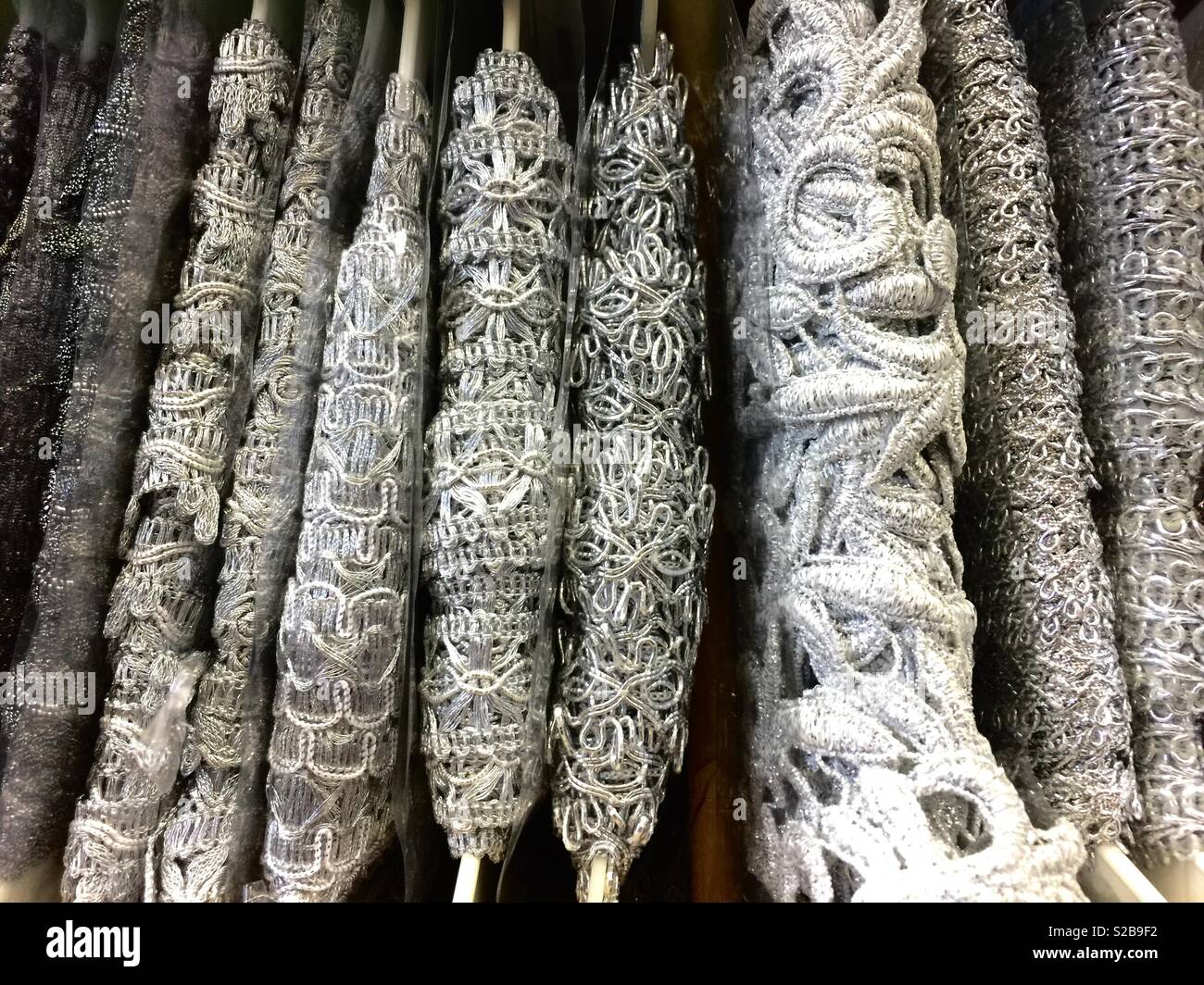 Silver brocade at sewing store. Stock Photo