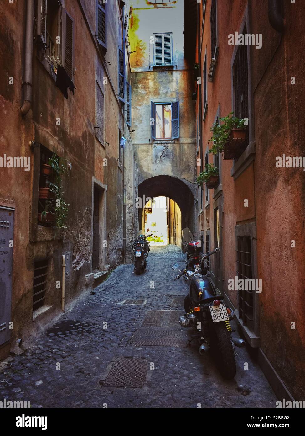 Motorcycles on a narrow cobblestone street in Rome - Smartphone Captured Stock Image