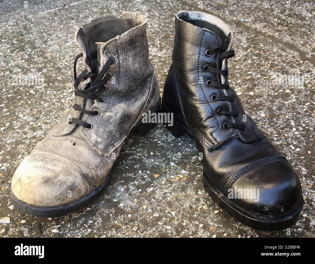 Out with the old, in with the new. Replacing my old army boots with a new pair. Stock Photo