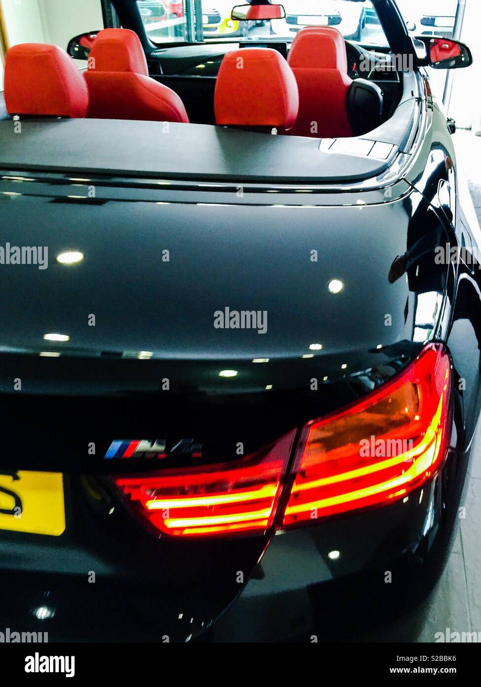 Brand new BMW M4 convertible in car showroom - Smartphone Captured Stock Image