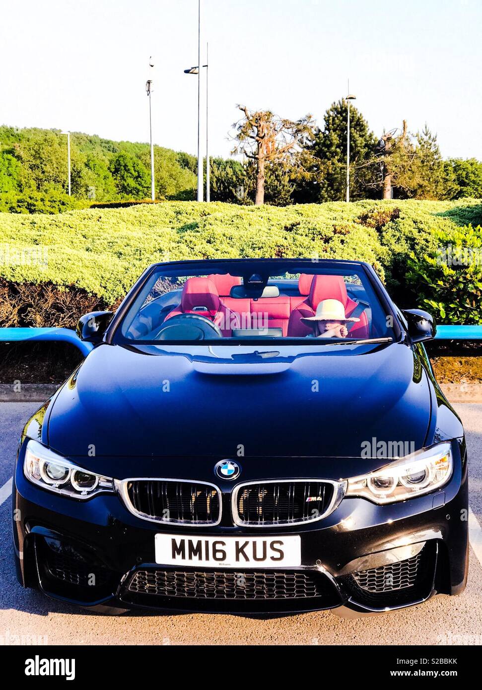 BMW M4 convertible parked with roof down Stock Photo