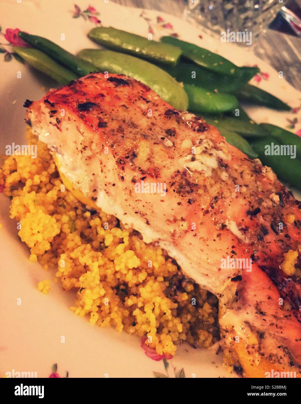 Gourmet entrée of broiled salmon on top of a bed of couscous, USA Stock