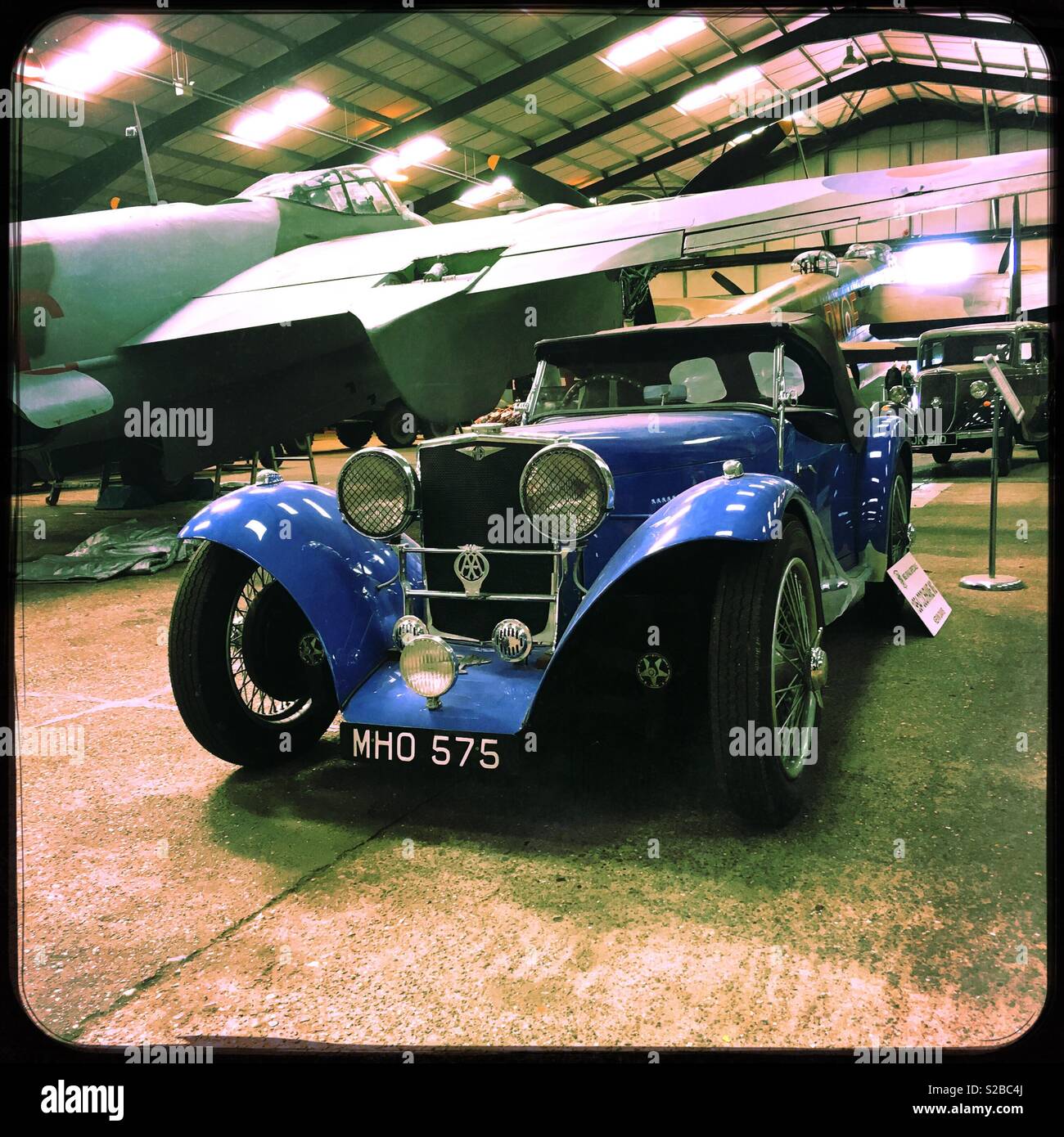 A 1954 MG TA Cochrane Special displayed next to a de Havilland Mosquito NFII aircraft. Lincolnshire Aviation Heritage Centre, East Kirkby, Lincolnshire, UK. - Smartphone Captured Stock Image