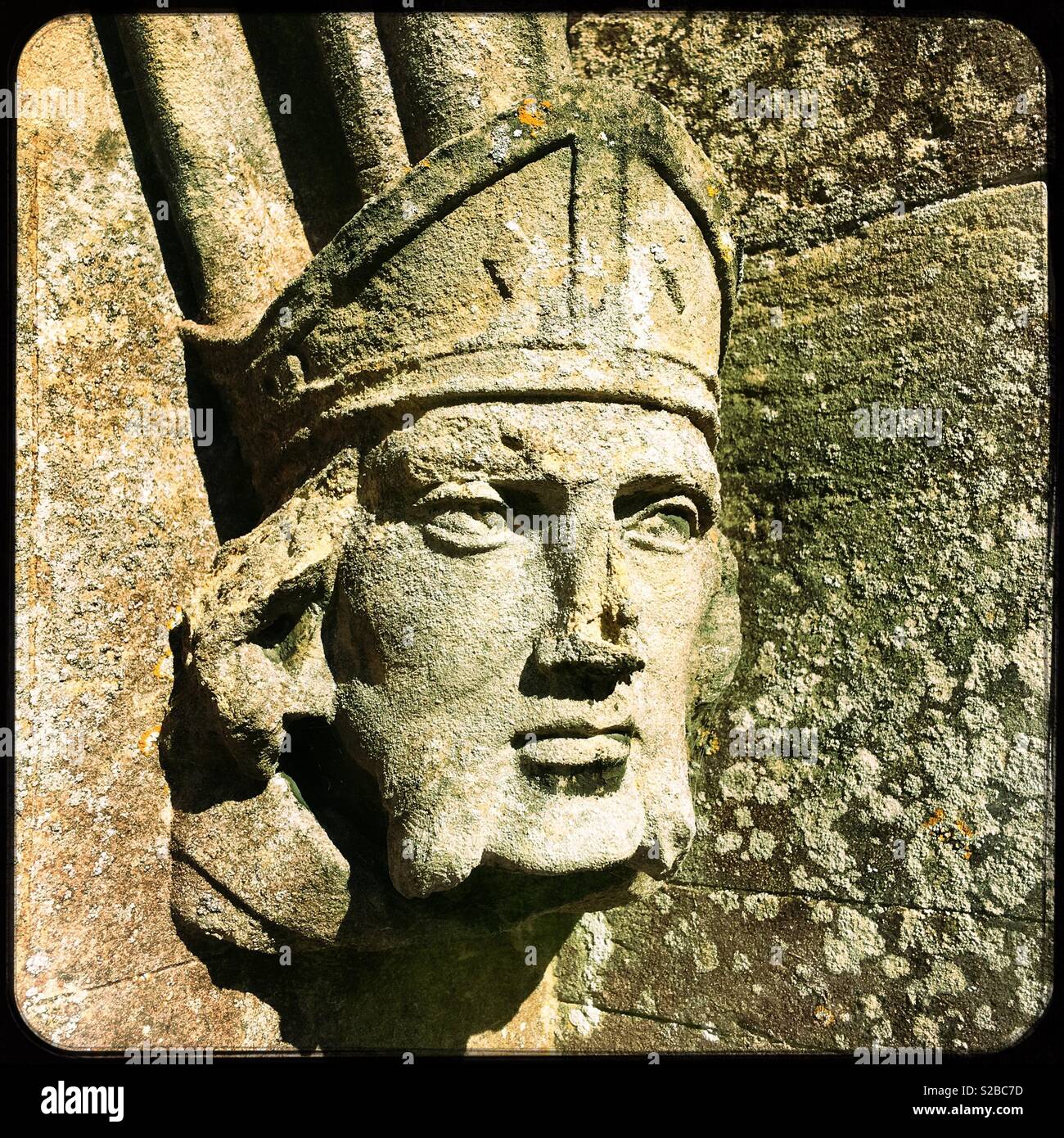 Carved stone head at St Peter’s church, North Rauceby, Lincolnshire, UK. - Smartphone Captured Stock Image