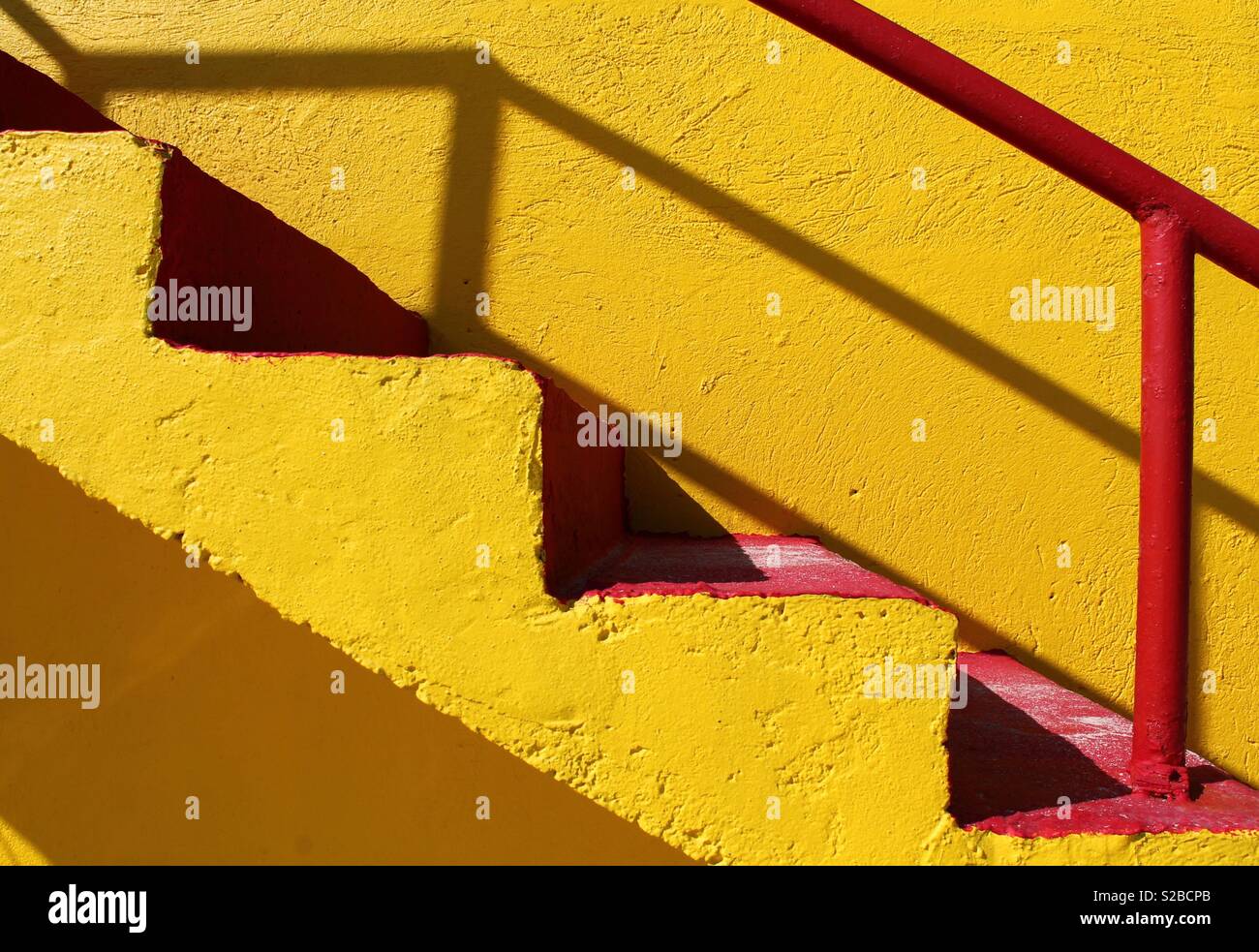 Yellow stairway with red steps Stock Photo