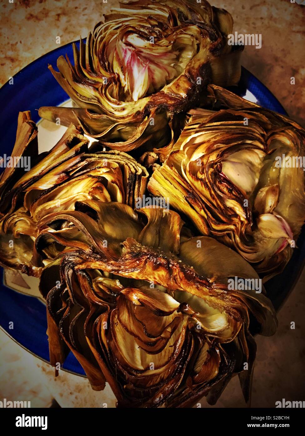 Roasted artichokes on a plate Stock Photo