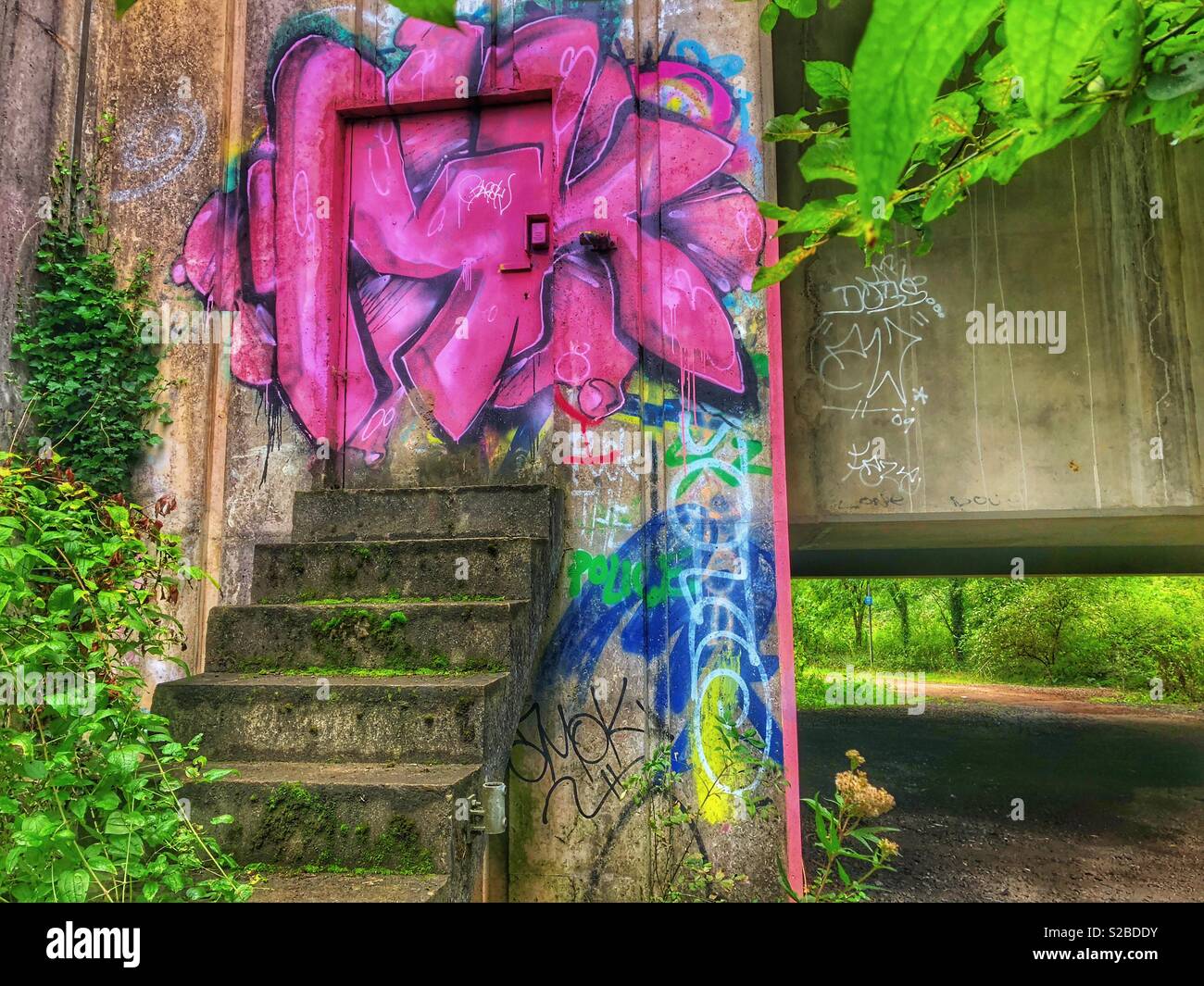 Graffiti on the doorway of an inspection chamber under a dual carriageway. - Smartphone Captured Stock Image