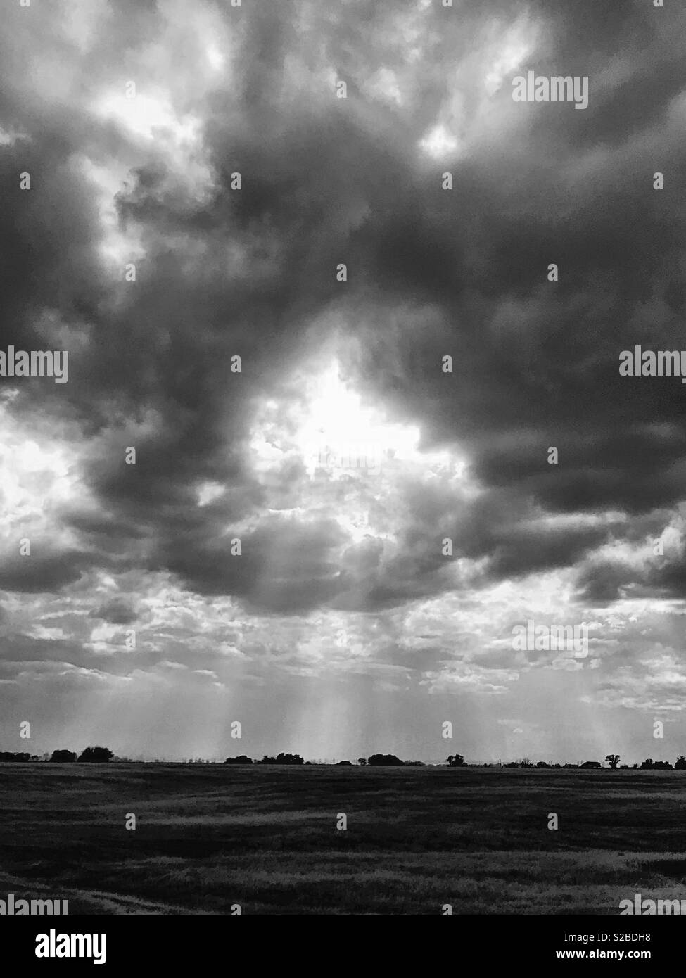 Sun rays through ominous clouds - Smartphone Captured Stock Image