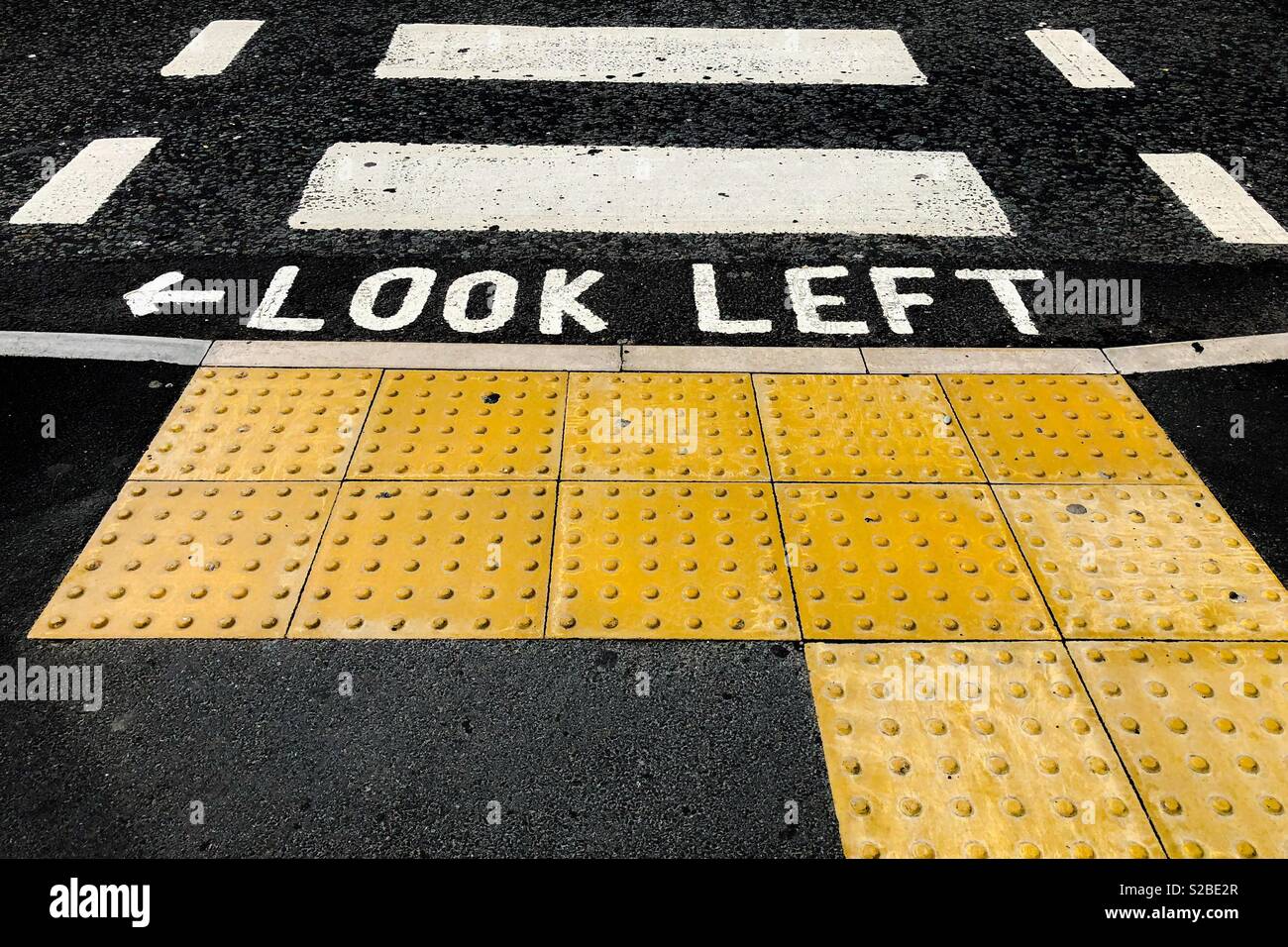 Look Left warning at a pedestrian crossing in England - Smartphone Captured Stock Image