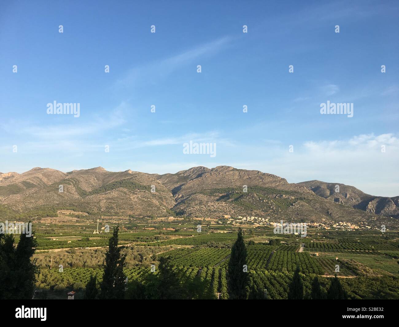 Early morning light falling on mountains near Tormos, Spain - Smartphone Captured Stock Image