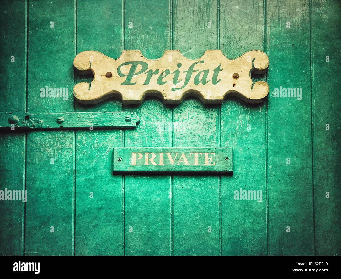 Preifat (Welsh) and Private (English) sign on wooden door - Smartphone Captured Stock Image