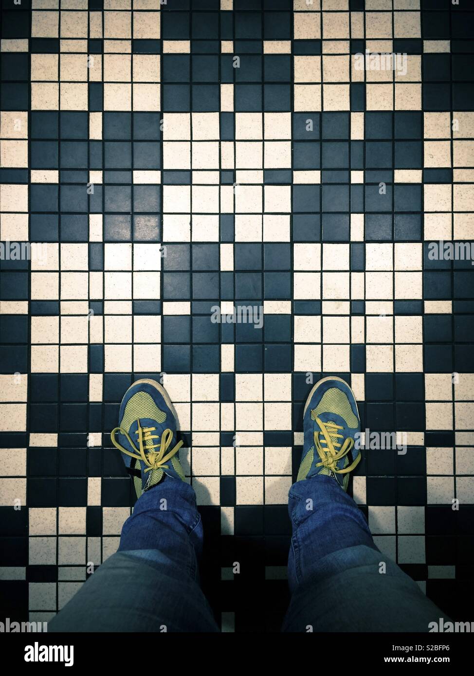 Selfportrait of feet above vintage tiles Stock Photo
