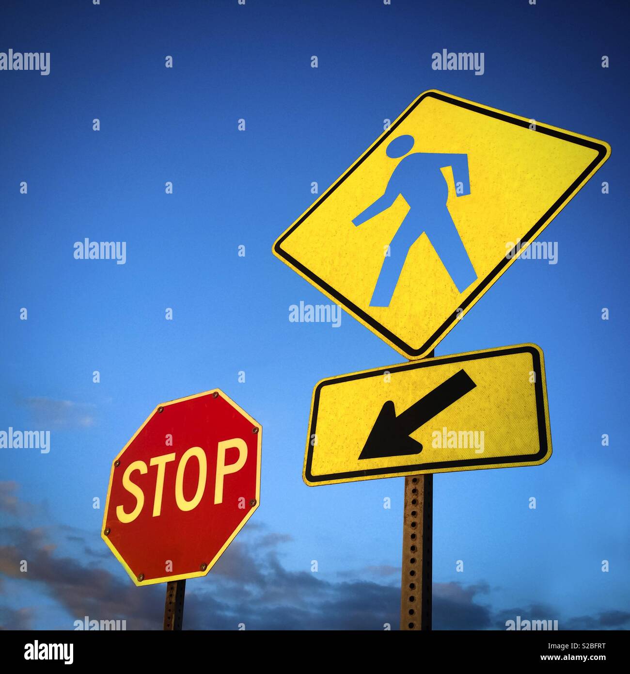 Conceptual crossing pedestrian and Stop signs - Smartphone Captured Stock Image