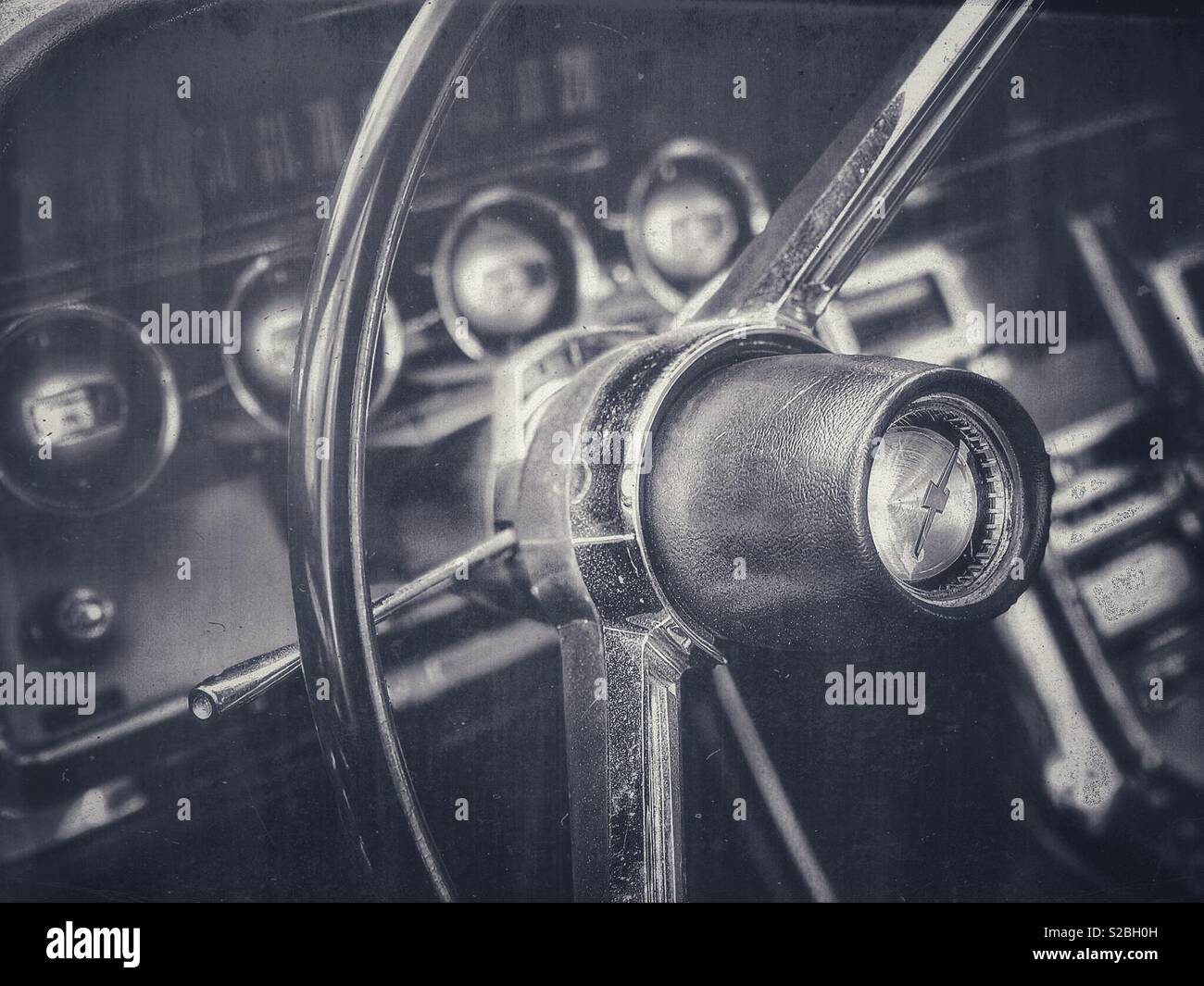 Vintage Chevrolet steering wheel and dashboard in black and white - Smartphone Captured Stock Image