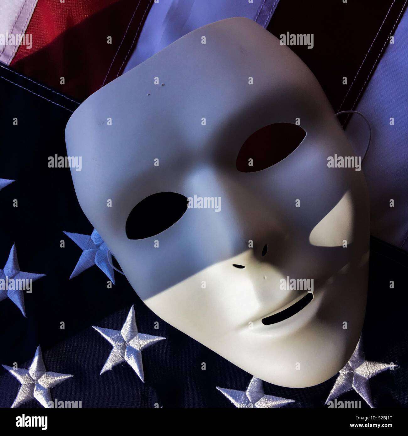 Blank white mask in shadows on United States flag - Smartphone Captured Stock Image