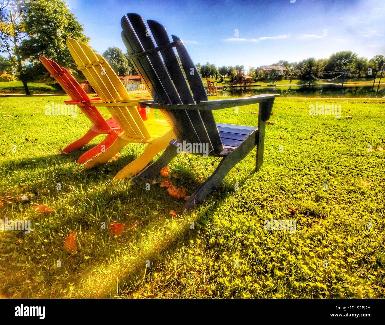Colorful Adirondack chairs on a lake shore - Smartphone Captured Stock Image