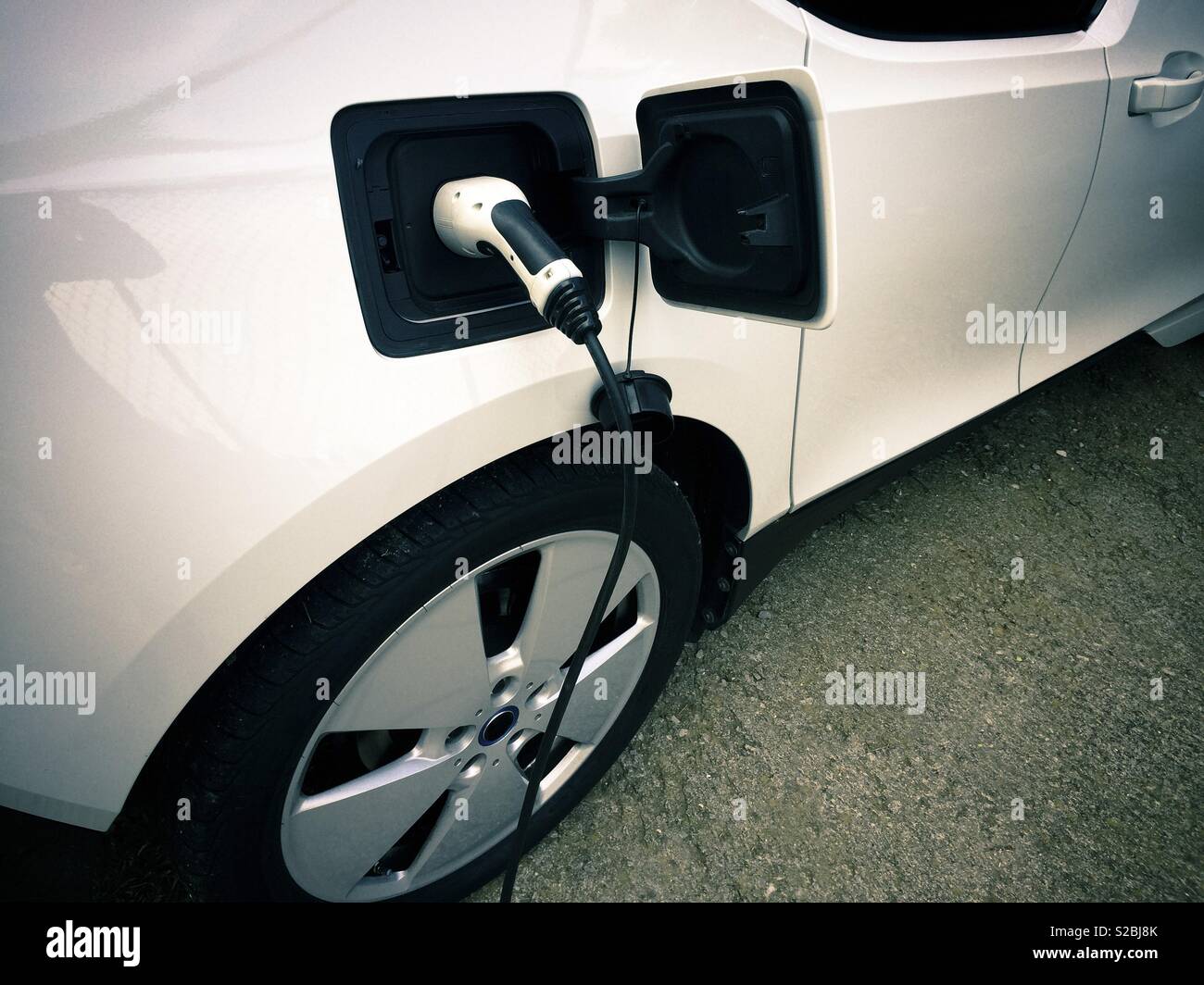 Electric car being charged at a charging station - Smartphone Captured Stock Image