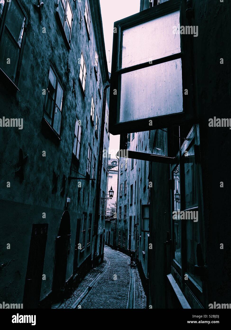 Open window in narrow atmospheric alleyway in Gamla Stan, Stockholm’s old town, Stockholm, Sweden - Smartphone Captured Stock Image