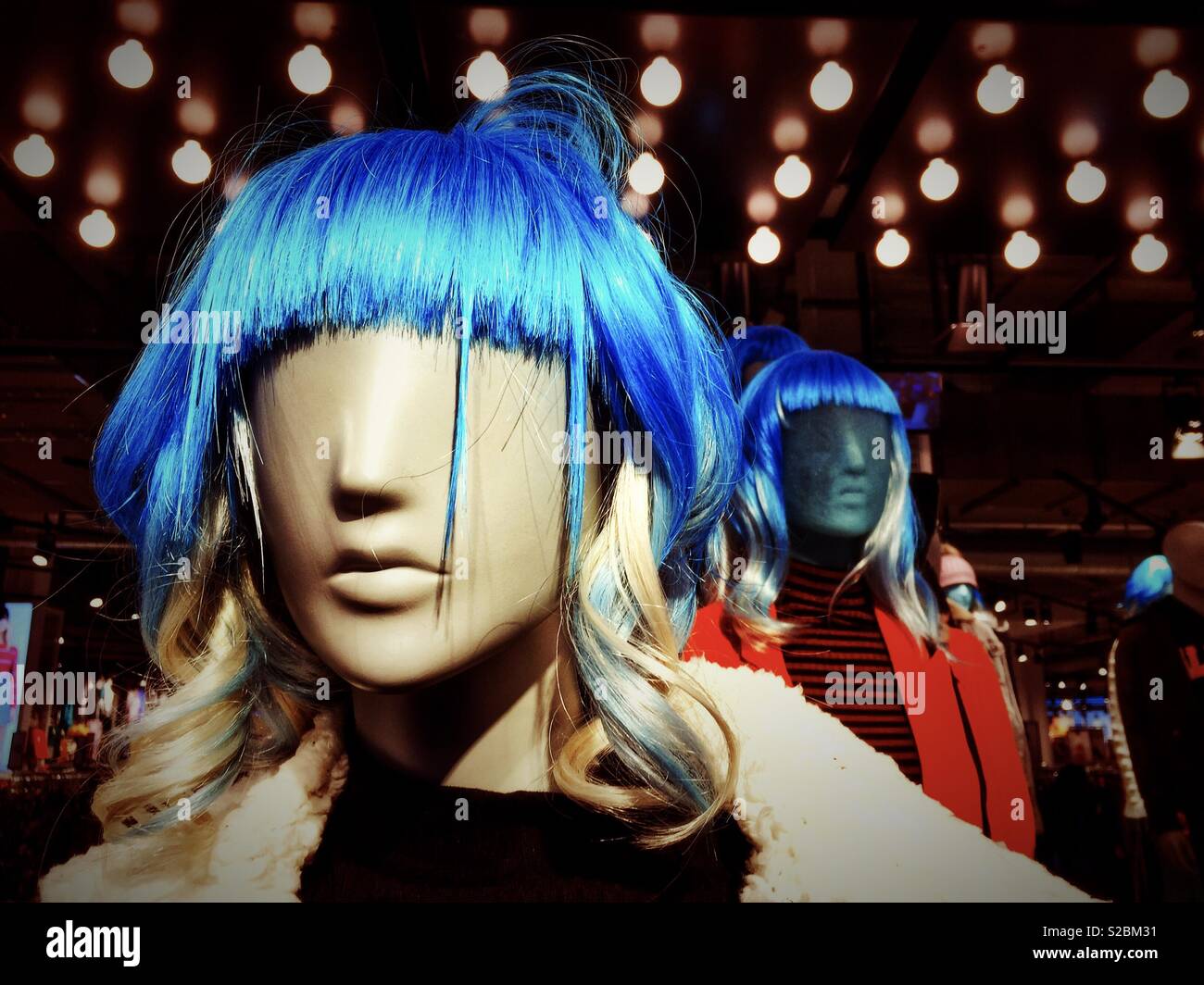 Mannequins wearing blue wigs in a clothes shop Stock Photo - Alamy