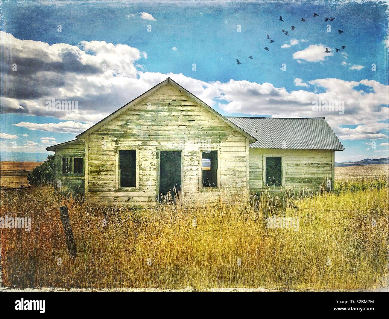 Vintage treatment of abandoned farmhouse in rural Montana - Smartphone Captured Stock Image