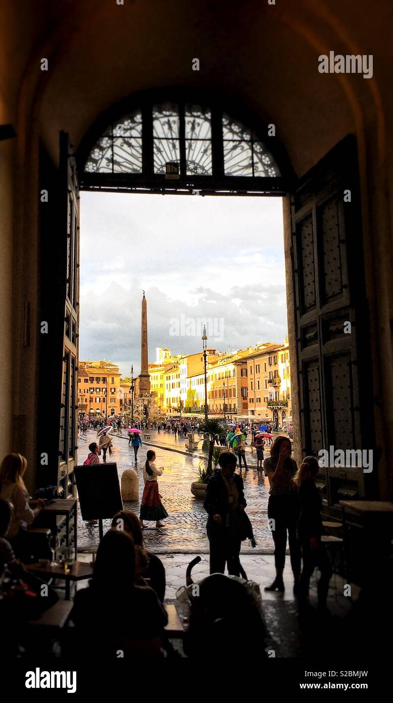 Piazza Navona seen through an arched doorway on a rainy afternoon - Smartphone Captured Stock Image