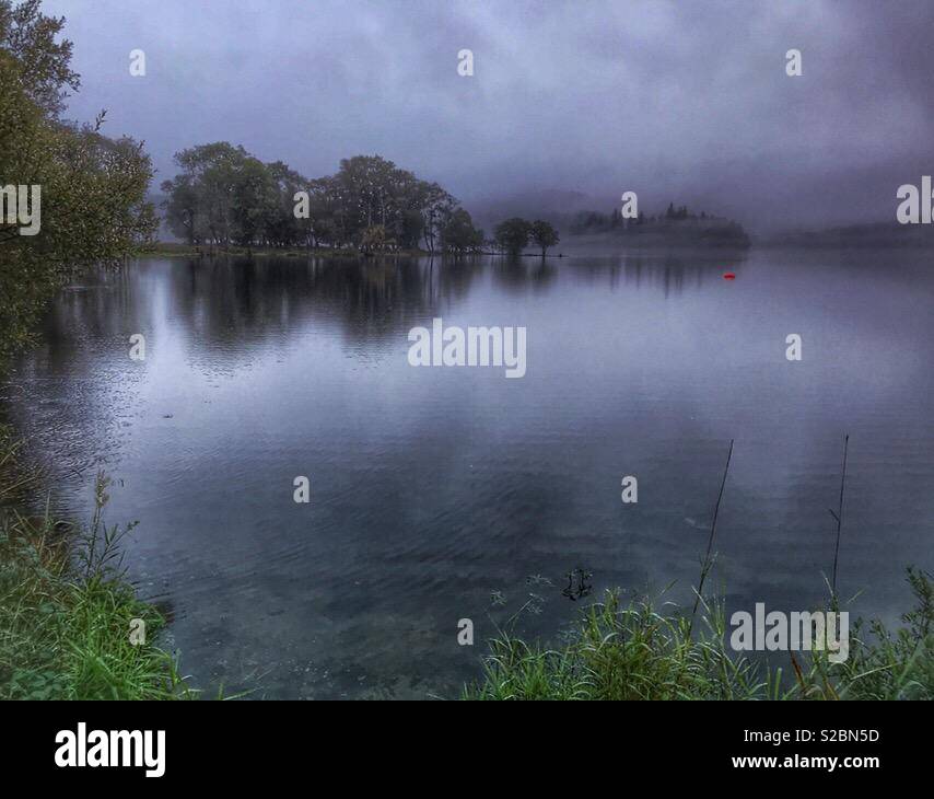 Morning mist on an overcast day, on a loch, Loch Lomond and The Trossachs National Park, Perthshire, Scotland - Smartphone Captured Stock Image