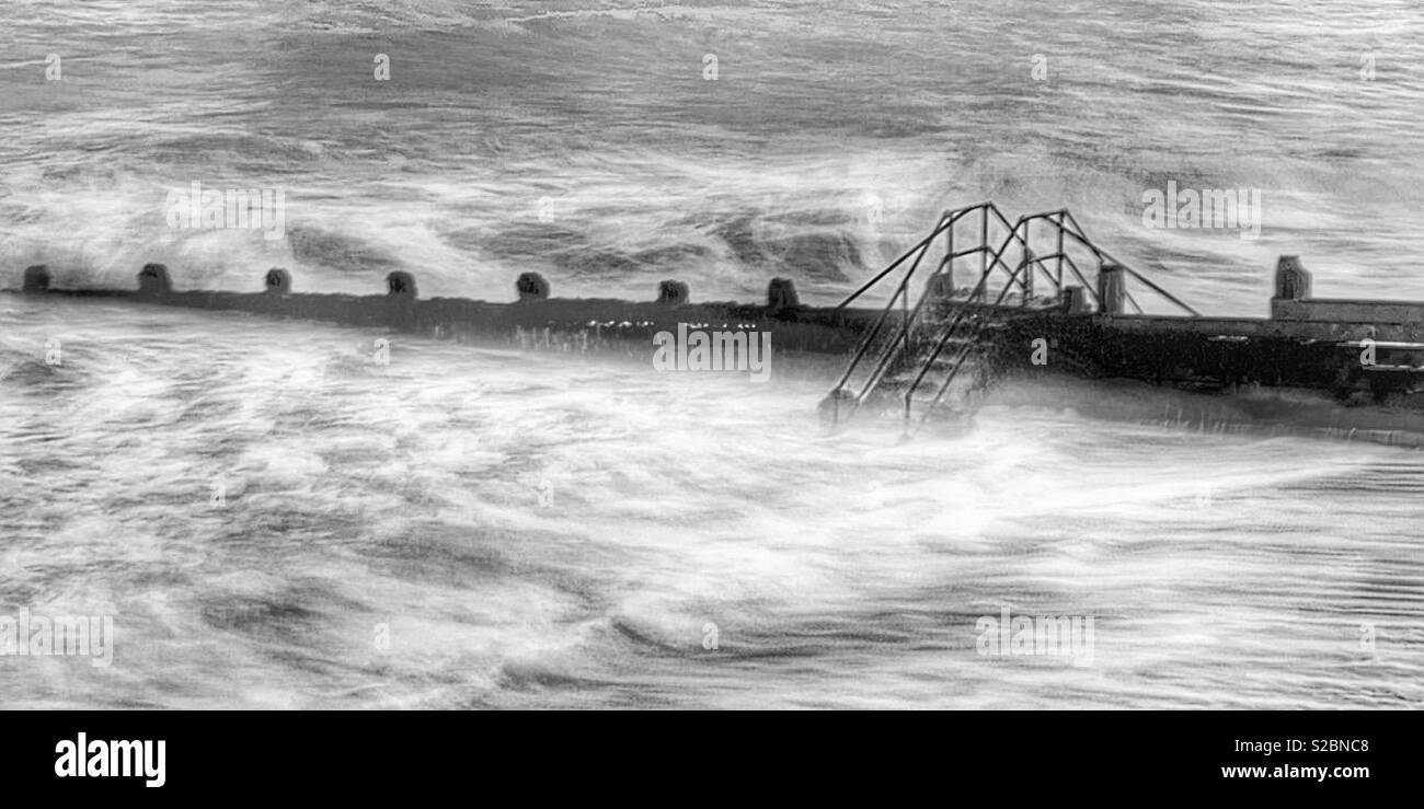 Grounds and a set of steps in the sea with wild sea over it in black and white. - Smartphone Captured Stock Image Grounds and a set of steps in the sea with wild sea over it in black and white. - Smartphone Captured Stock Image