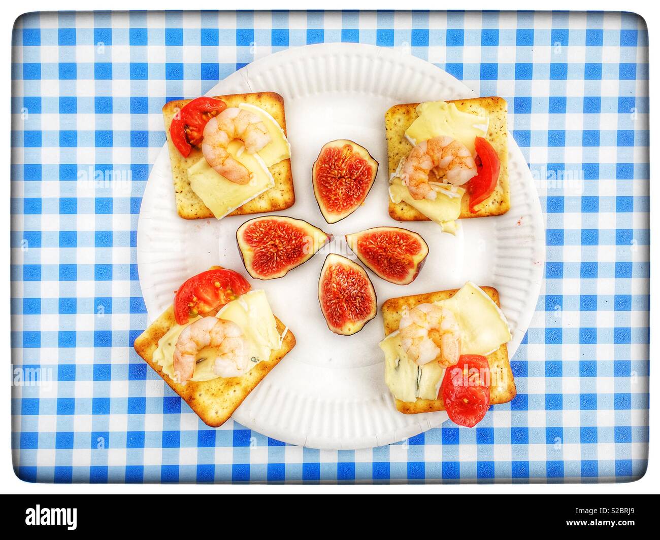 Crackers with cheese tomato and prawns and fresh figs - Smartphone Captured Stock Image