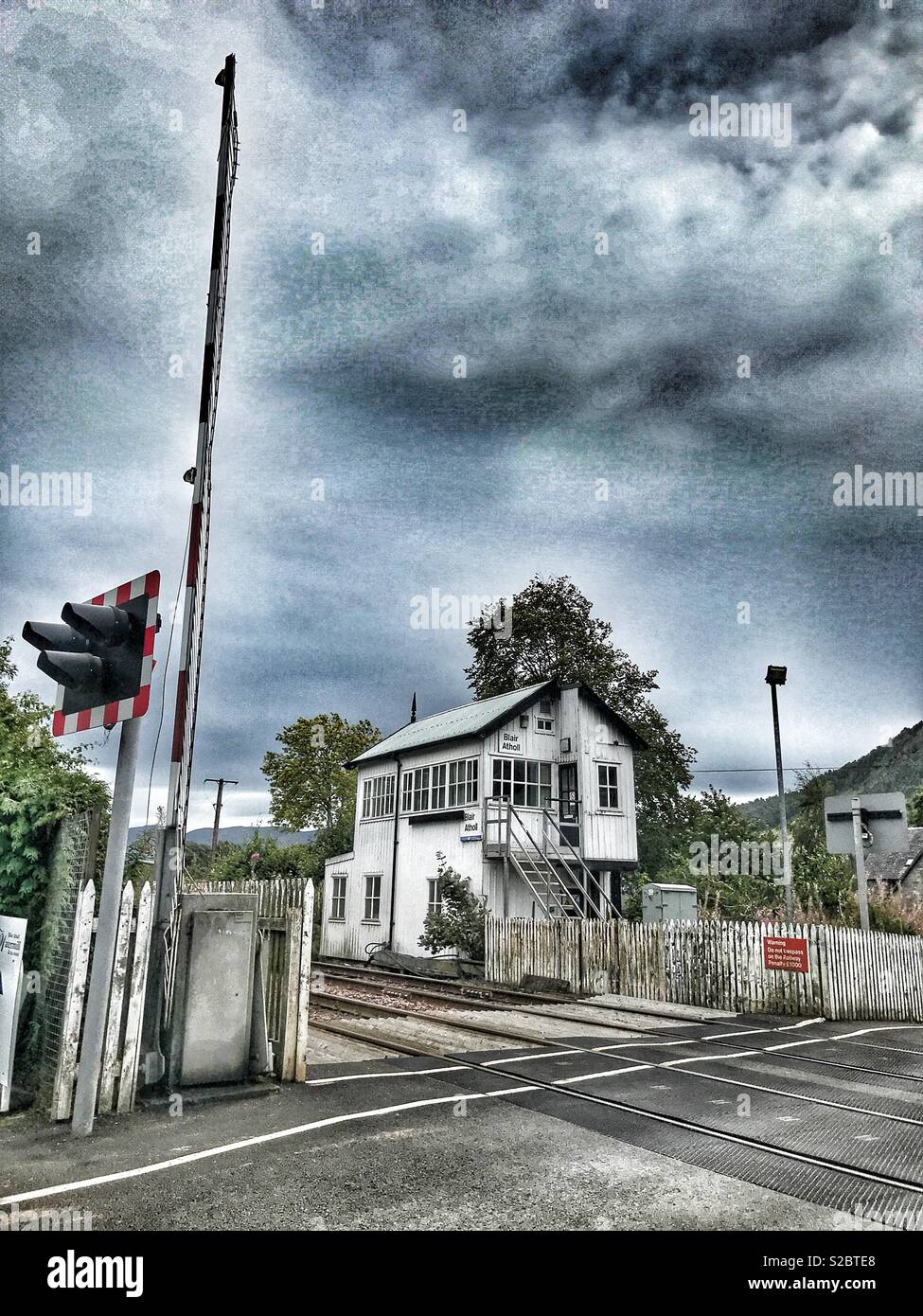 Blair Atholl train station, railway crossing, signal up, Perthshire, Scotland - Smartphone Captured Stock Image