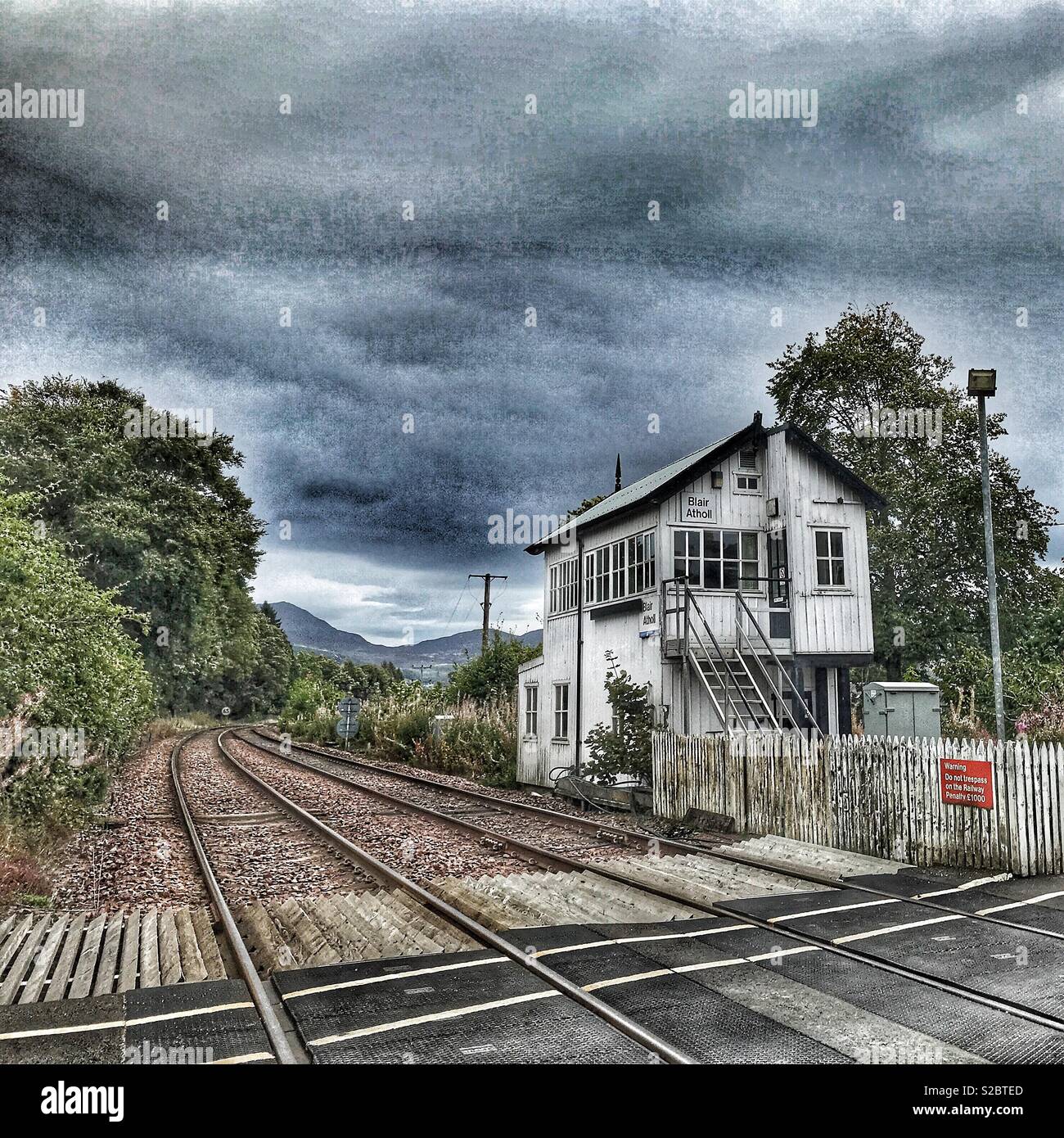Blair Atholl train station, railway crossing, rail tracks and road