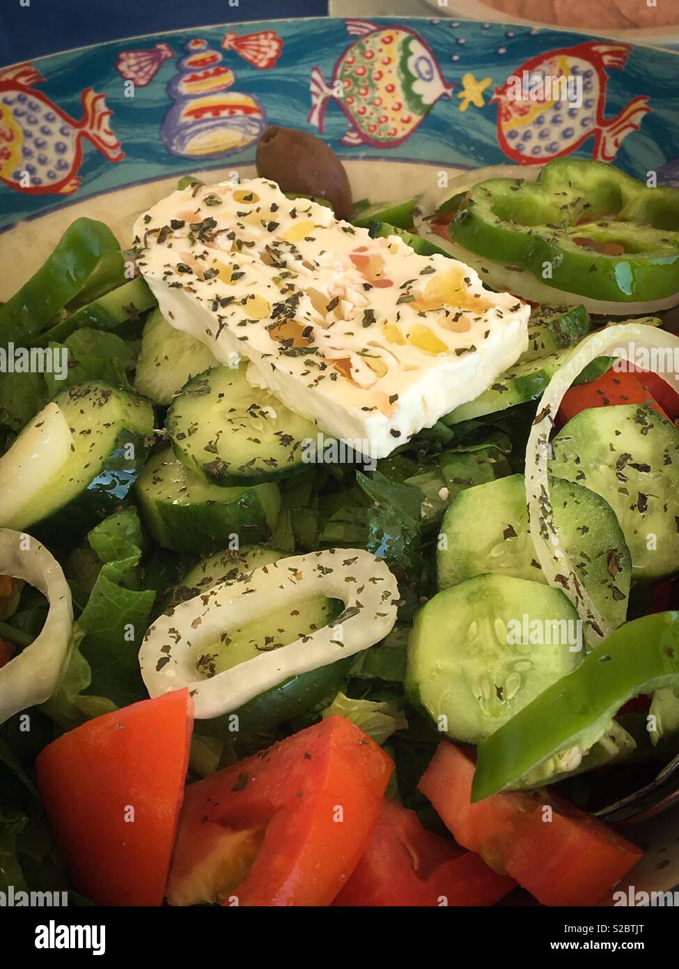 Cypriot Greek village salad with feta cheese, tomatoes, cucumber and lettuce. Stock Photo