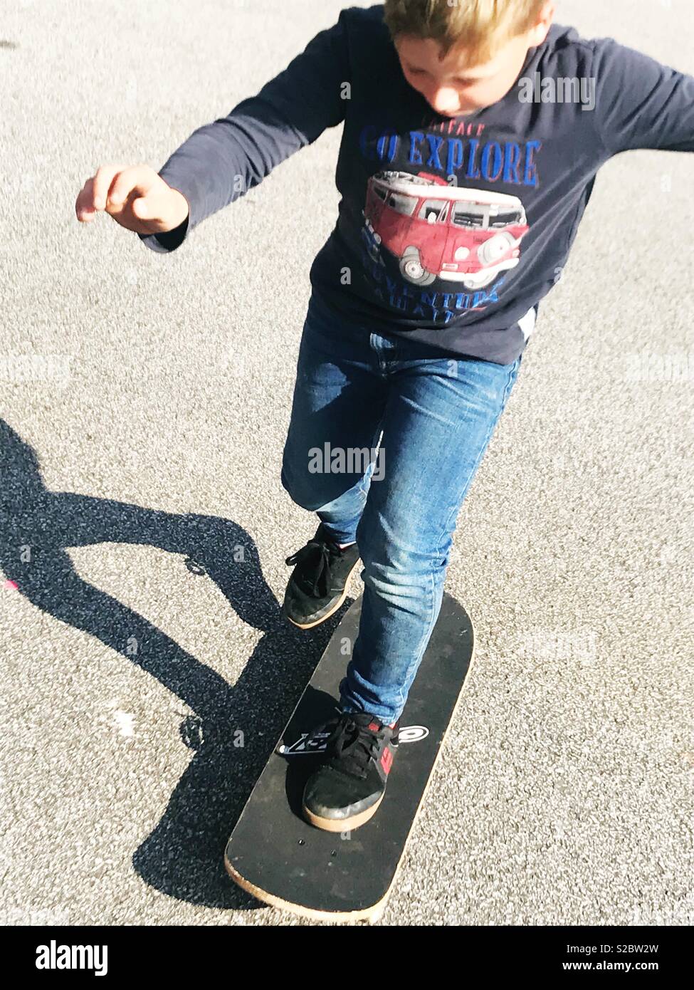 Skateboarding boy in the sun Stock Photo Alamy