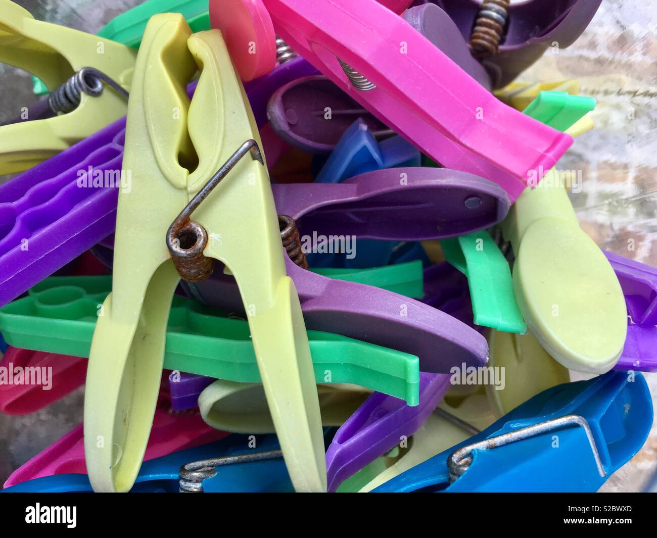 Plastic clothes pegs in bright colours Stock Photo