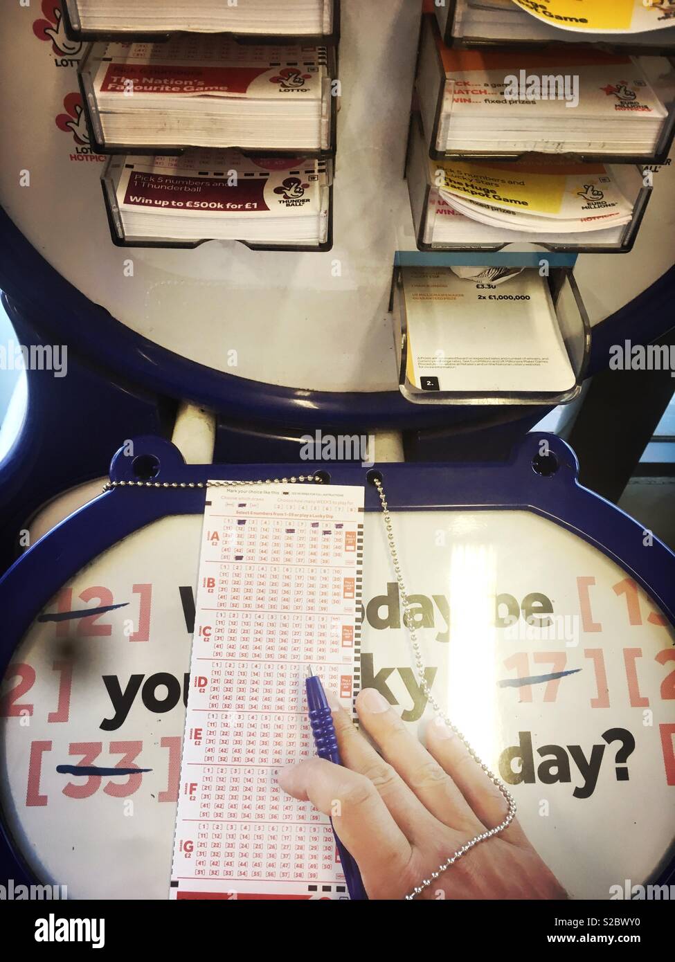 Man playing national lottery - Smartphone Captured Stock Image