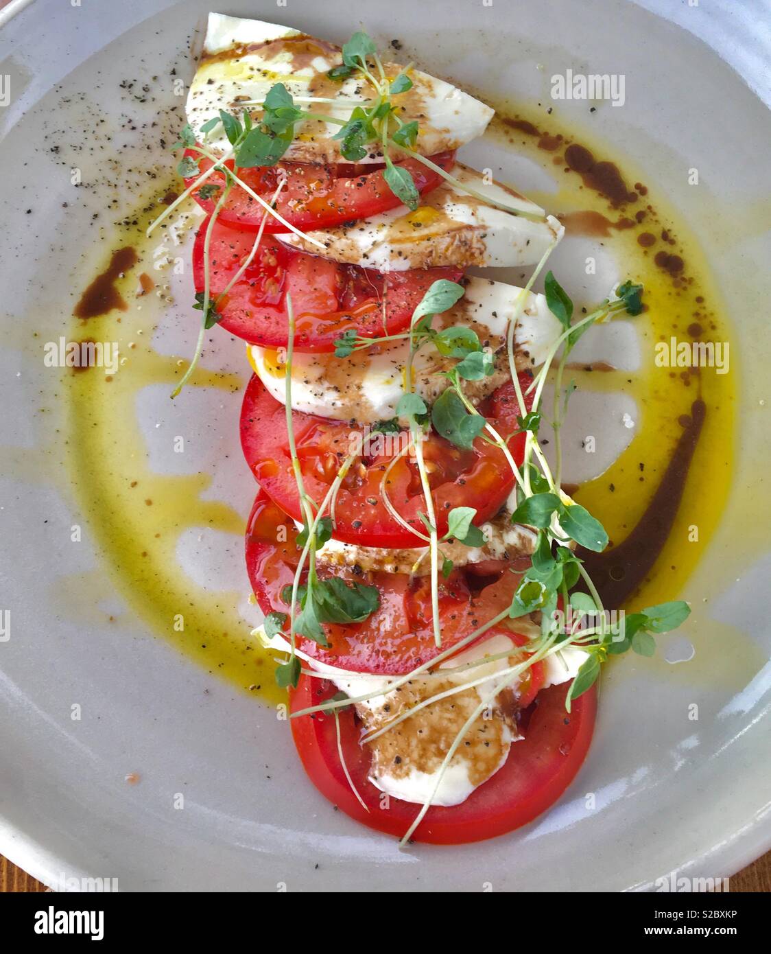 Fresh tomato and mozzarella salad with cress balsamic vinegar and olive oil Stock Photo Alamy