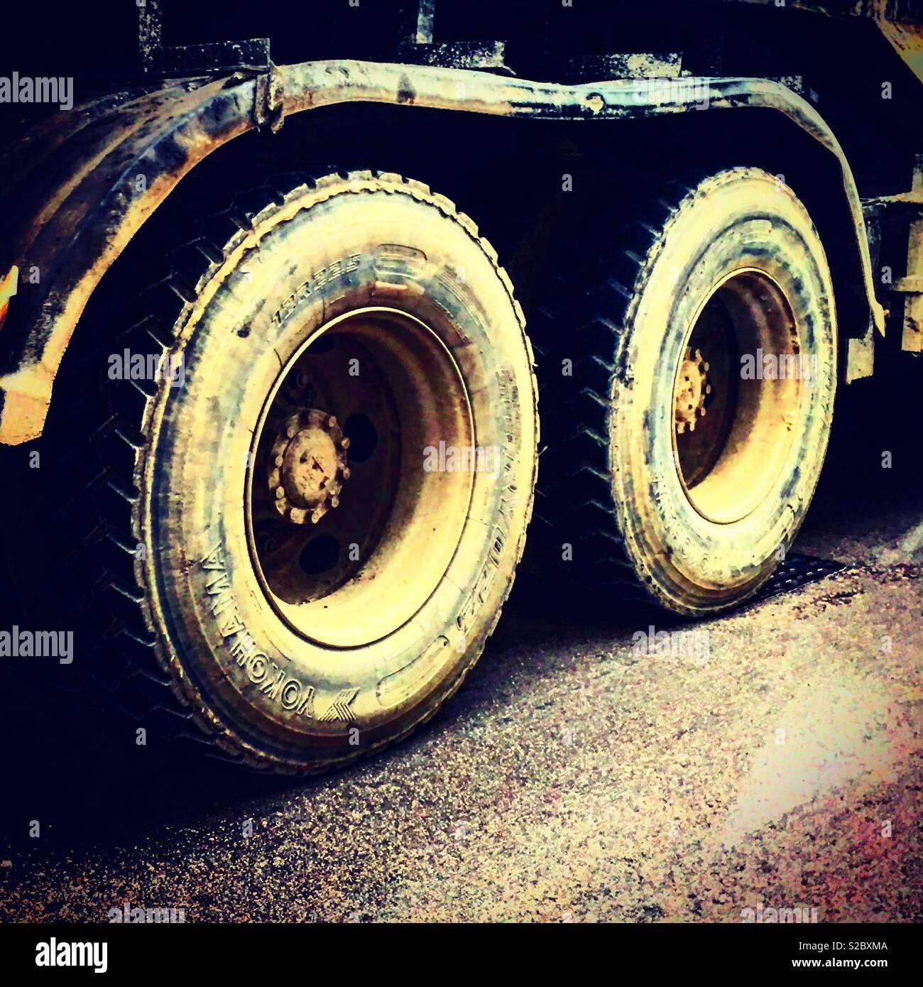 Dirty double wheels of a construction site truck or lorry Stock Photo