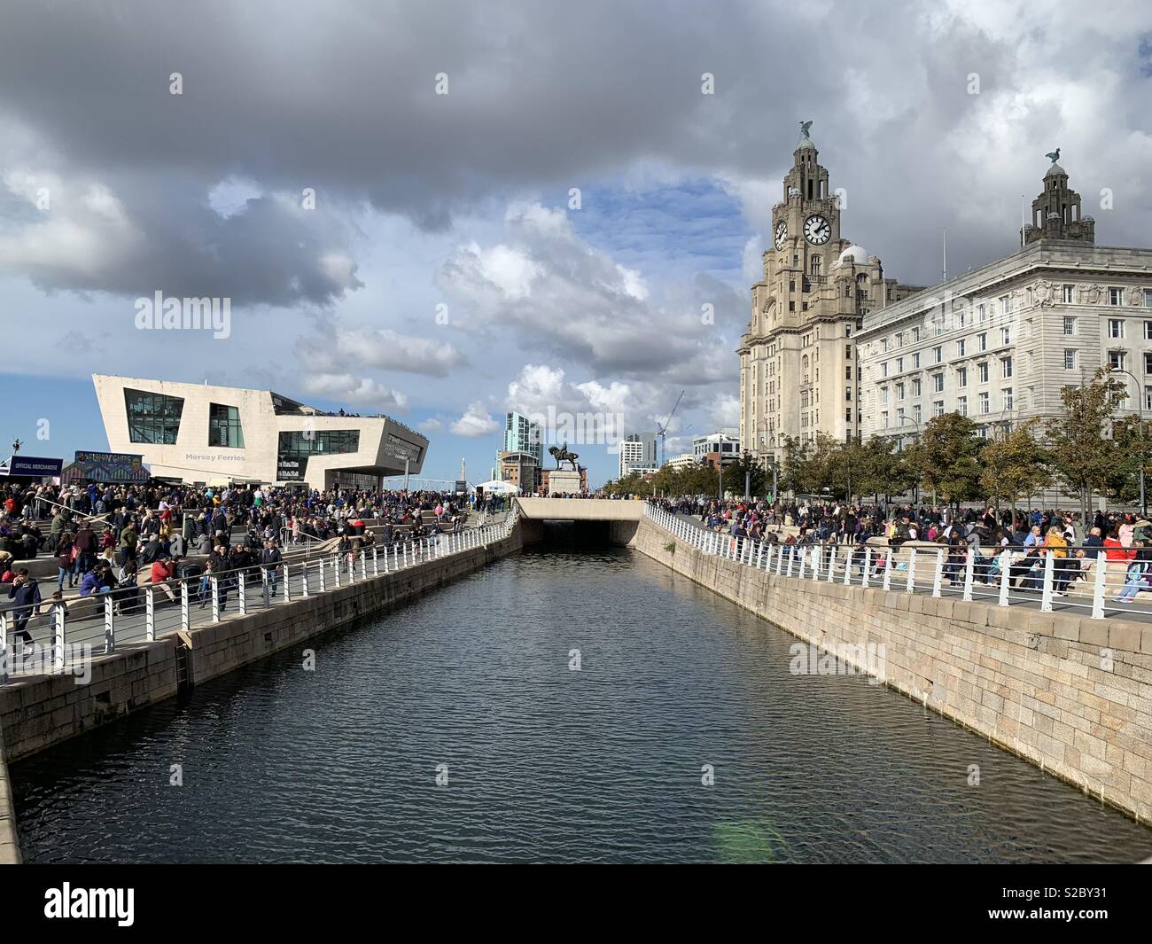 Crowds gather at Liverpool waterfront near Liver Buildings Stock Photo
