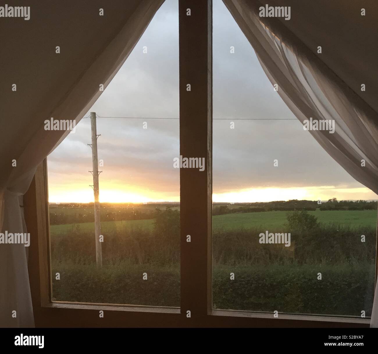 Sunset view from bedroom window in the UK countryside. Stock Photo