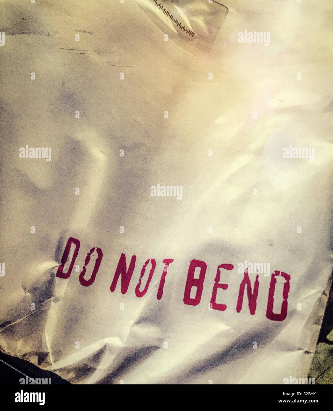Crumpled large envelope with the words do not bend stamped on it, United States Stock Photo