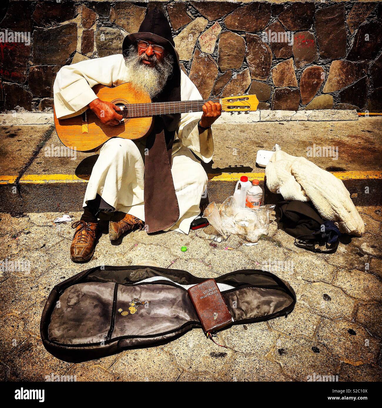 A Catholic monk plays the guitar in Cerro del Cubilete, in the Cristo Rey or Christ the King hill in Silao, Guanajuato, Mexico Stock Photo