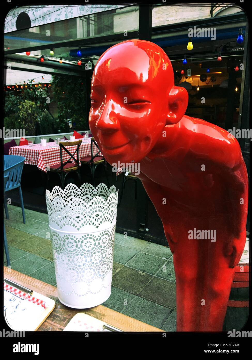 Mannakin welcoming customers to the Hollo 10 bistro in the Jewish Quarter of Budapest, Hungary. - Smartphone Captured Stock Image