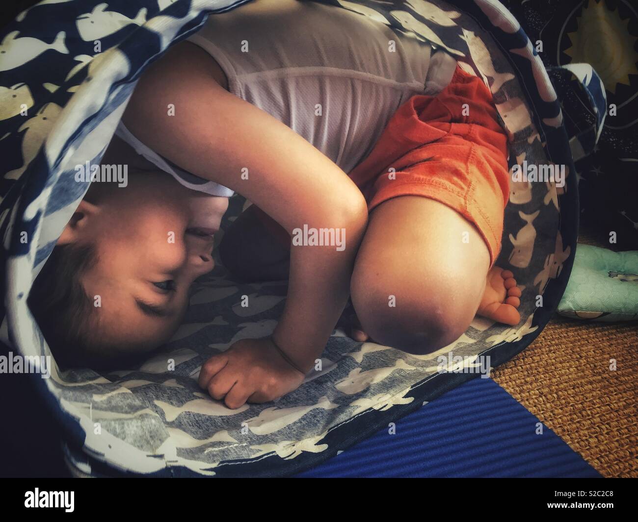 A boy hiding in a basket - Smartphone Captured Stock Image