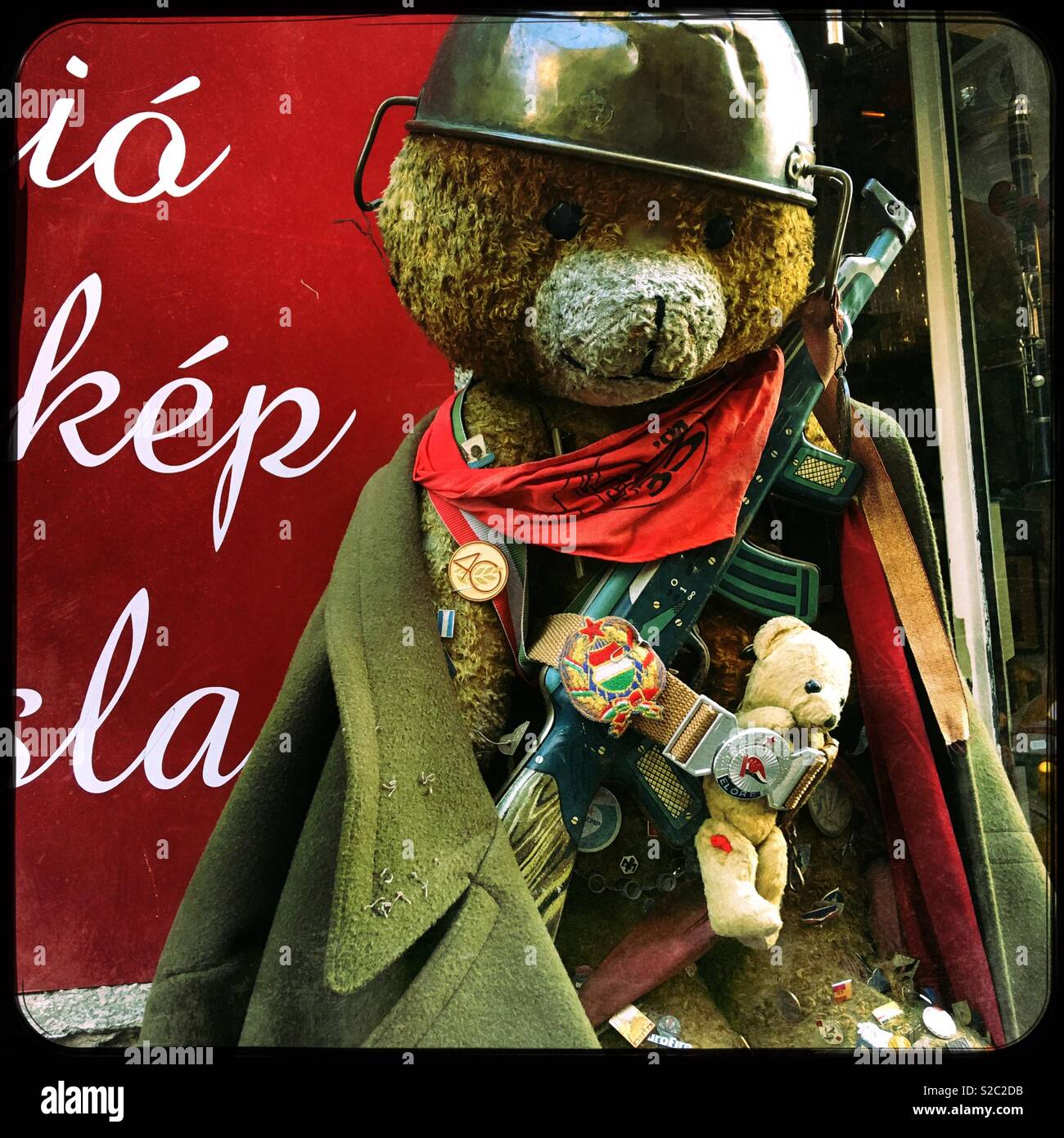 Large teddy bear dressed as a Russian soldier outside the Nostalgia Antiques Bazaar in the Jewish Quarter of Budapest, Hungary. Stock Photo