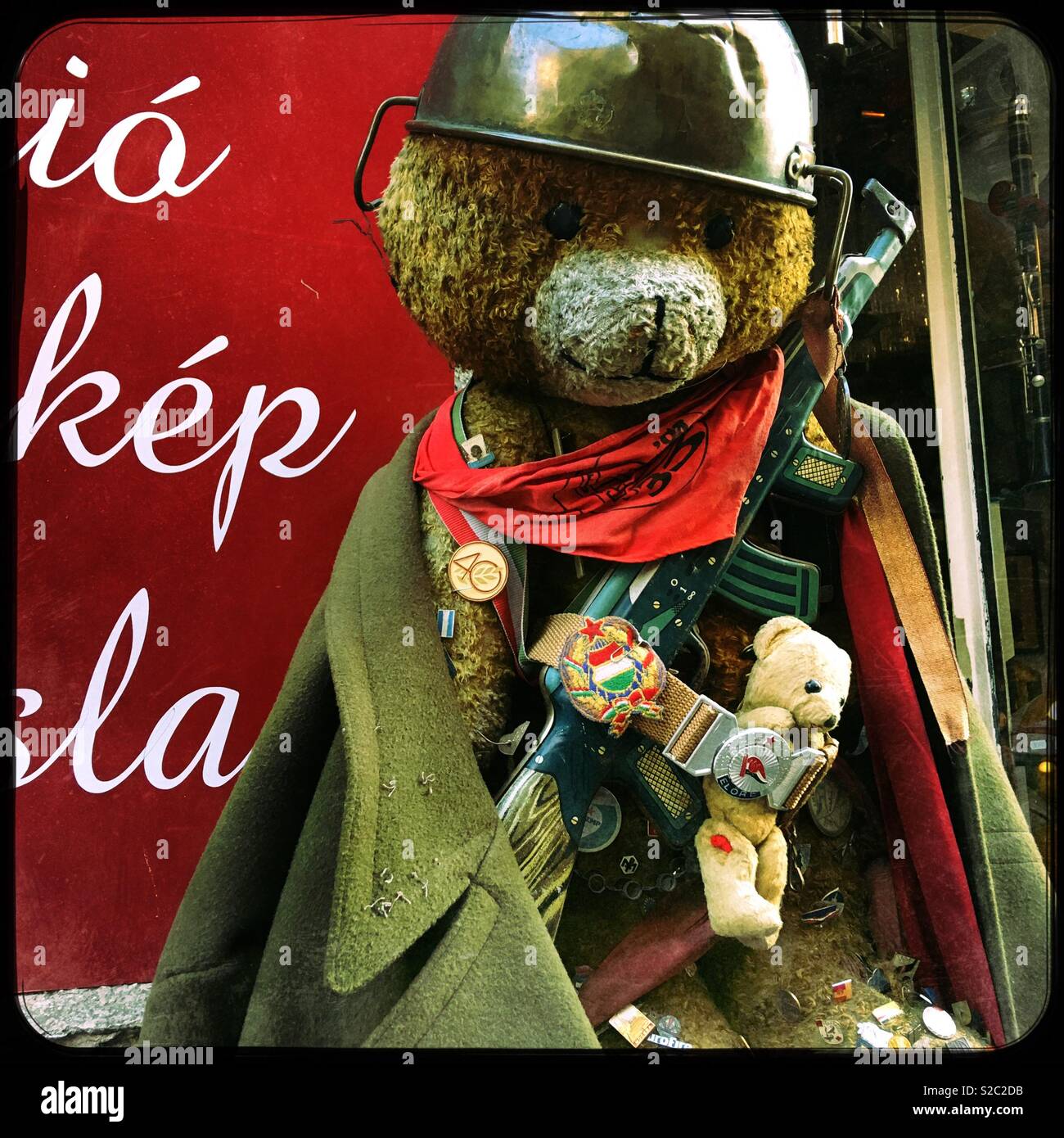 Large teddy bear dressed as a Russian soldier outside the Nostalgia Antiques Bazaar in the Jewish Quarter of Budapest, Hungary. - Smartphone Captured Stock Image