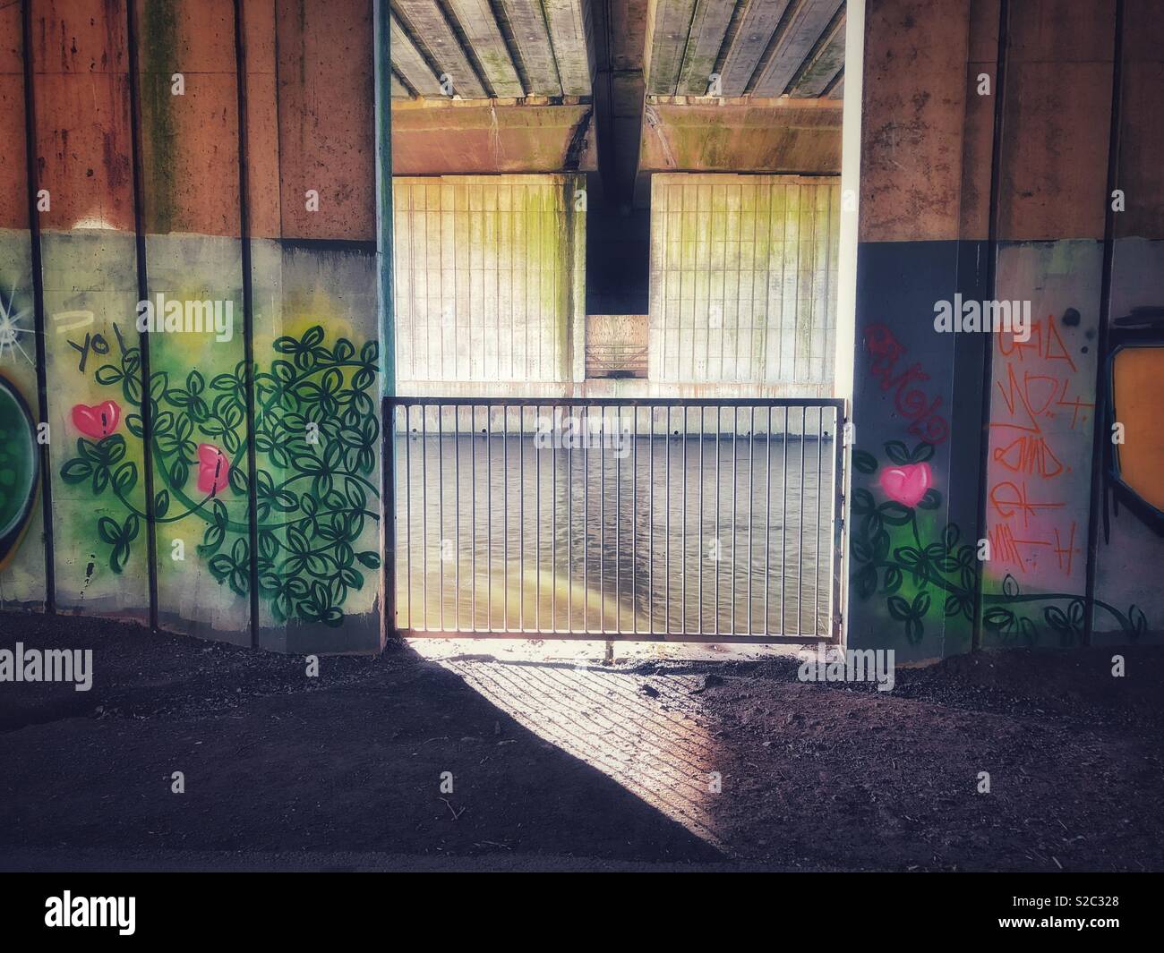 Graffiti on a road bridge over the river Taff, Cardiff Wales. The river can be seen beyond the railings. - Smartphone Captured Stock Image Graffiti on a road bridge over the river Taff, Cardiff Wales. The river can be seen beyond the railings. - Smartphone Captured Stock Image