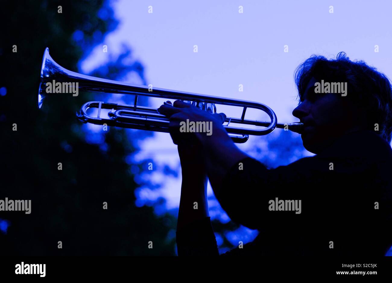 Sunset silhouette, musician playing trumpet - Smartphone Captured Stock Image