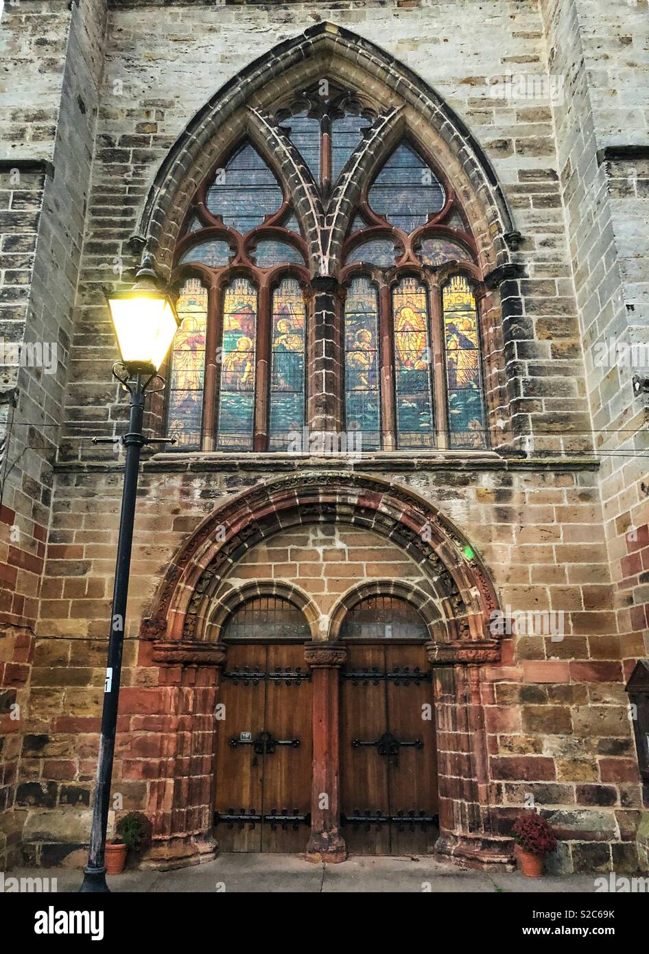Front of St Mary’s Parish Church with stained glass window at twilight, Haddington, East Lothian, Scotland, UK - Smartphone Captured Stock Image