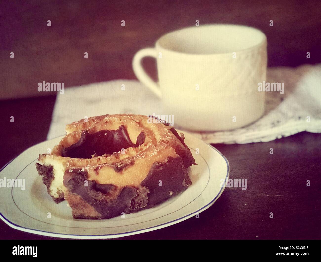 Coffee and chocolate crumble cake donut on fine china wear, America, USA Stock Photo