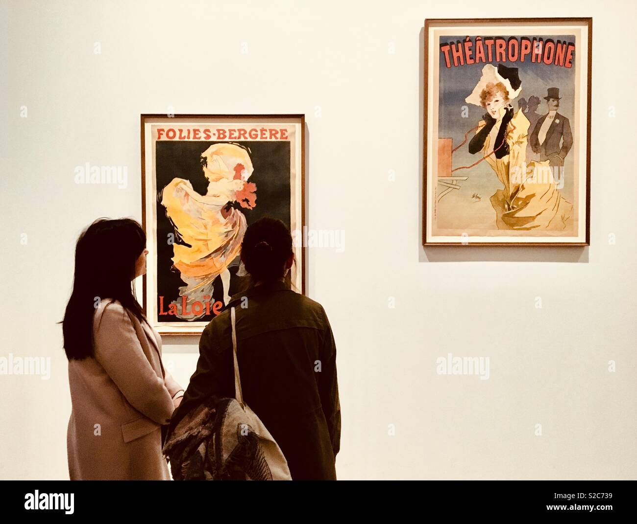 Women looking at artwork in art gallery - Smartphone Captured Stock Image