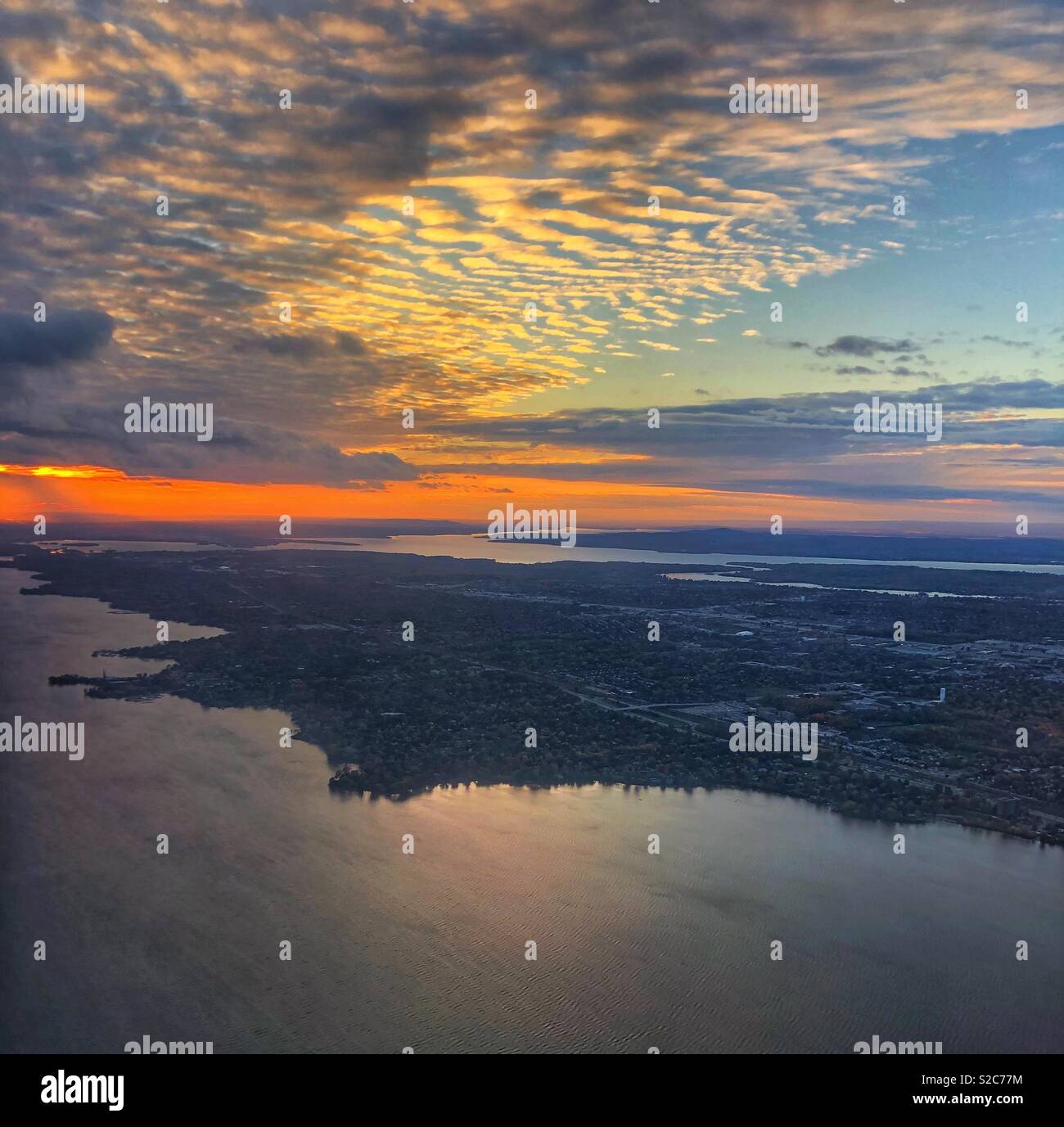 Flying over Montreal into the sunset. Stock Photo